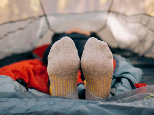 feet sticking out of a tent