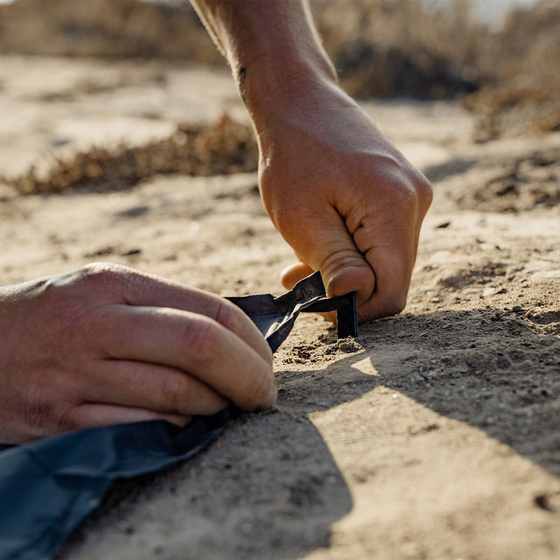 Matador Pocket Blanket 3.0--ground stake in the sand