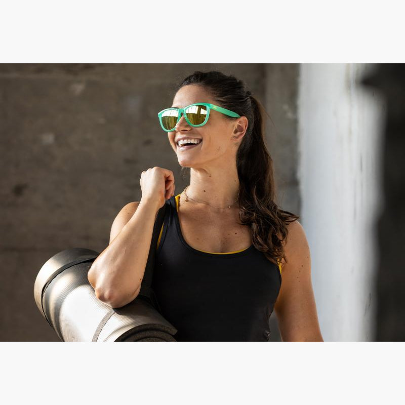 Knockaround Jelly Melon Yellow Sport Sunglasses on a woman at the gym
