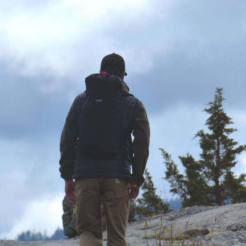 A man wears the Crag Pack hiking.