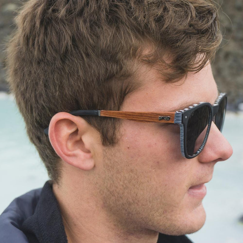 A man wears Scout Eco Black/Polarized Lens shades from Proof.