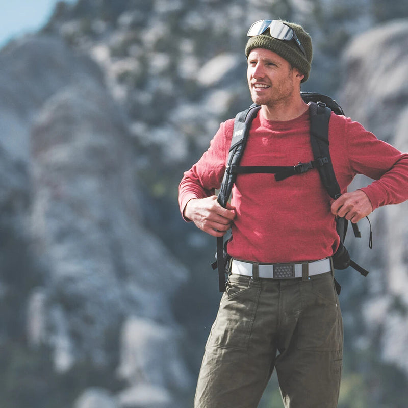 a man standing on a mountain wearing a grip6 belt