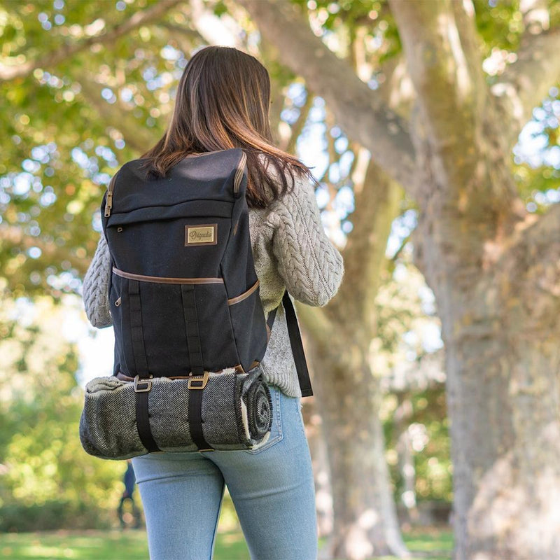 A woman carries the Black Finley Mill Pack