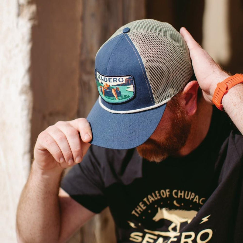 man putting on a sendero provisions co rio hat