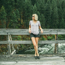 A woman wears Ada Eco Yellow Tortoiseshell/Brown Polarized Lens shades on a bridge.