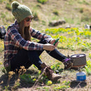 A girl sits on the ground wearing Proof eyewear.