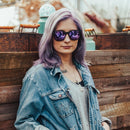 A woman rocks a pair of shades.