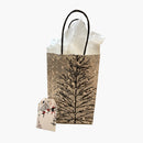 Holiday gift back filled with tissue paper and a card 