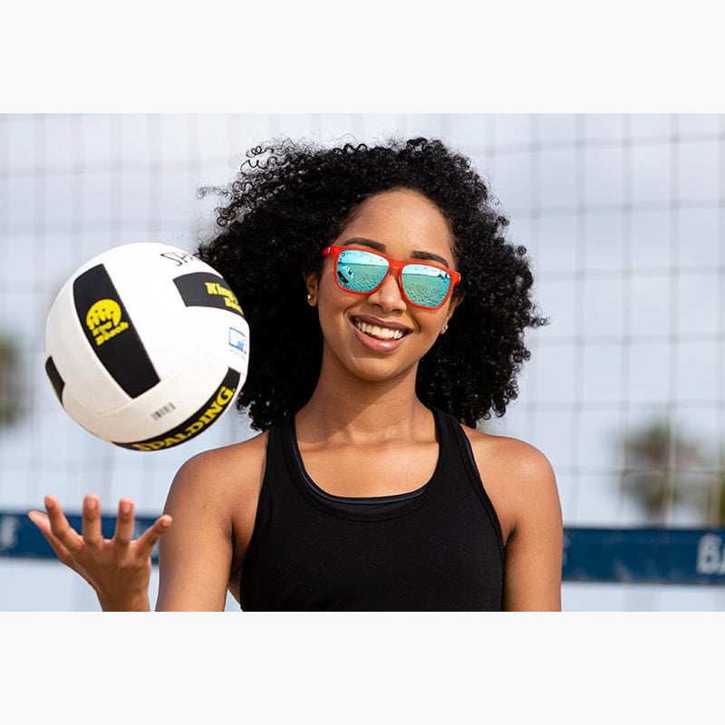 Knockaround Fruit Punch Aqua Fast Lanes Sport Sunglasses on a girl playing volleyball