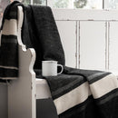 advanced primate elliston blanket--draped over a white wooden bench