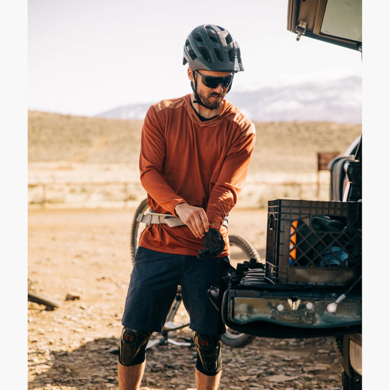 Yuba Long Sleeve Brick Hoodie on a man getting ready for mountain biking