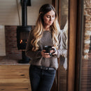 A woman wears the Grip6 Women's Classic Gunmetal Belt in grey.