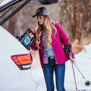 A woman wears the Grip6 Women's Sego Lily Belt while preparing to cross country ski.