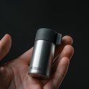 water proof travel cannister 40 ml held in palm of hand