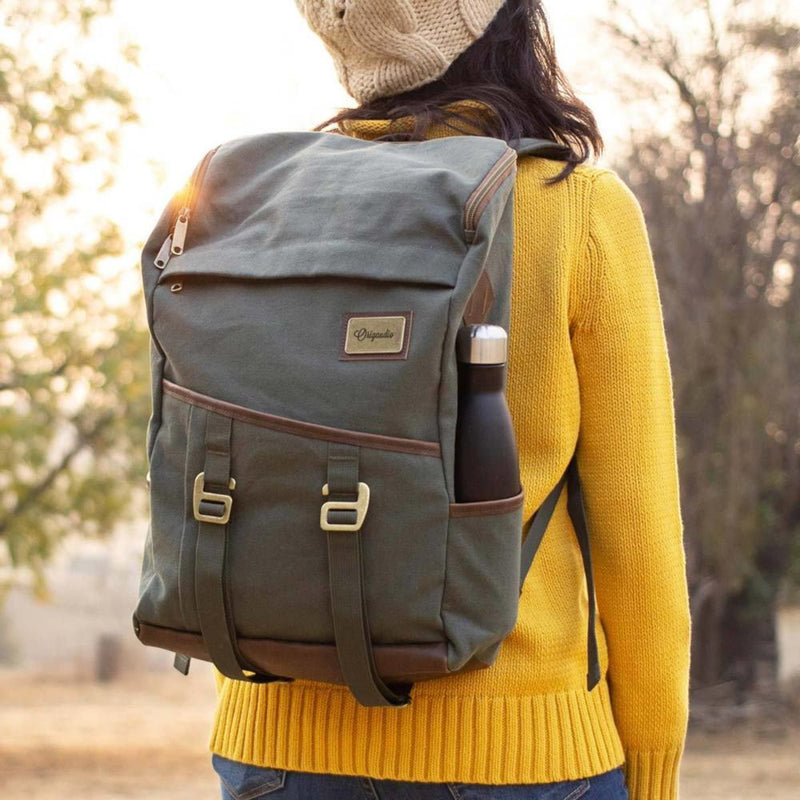 A woman carries Green Finley Mill Pack