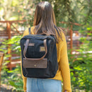 A woman wears the Black Turlee Tote