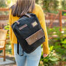 A woman carries the Black Turlee Tote