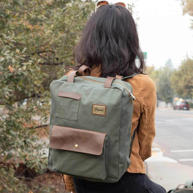 A woman wears the Green Turlee Tote