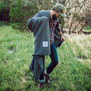 Trek Light Gear Greyson Blanket--man walking through a meadow