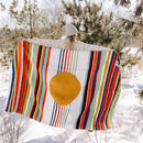 Trek Light Gear Halley's Comet Blanket--girl holding blanket against her back in snow