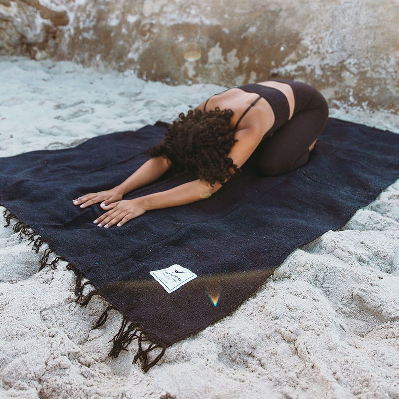 Trek Light Gear Newport Blanket--woman doing yoga stretch on a blanket at the beach